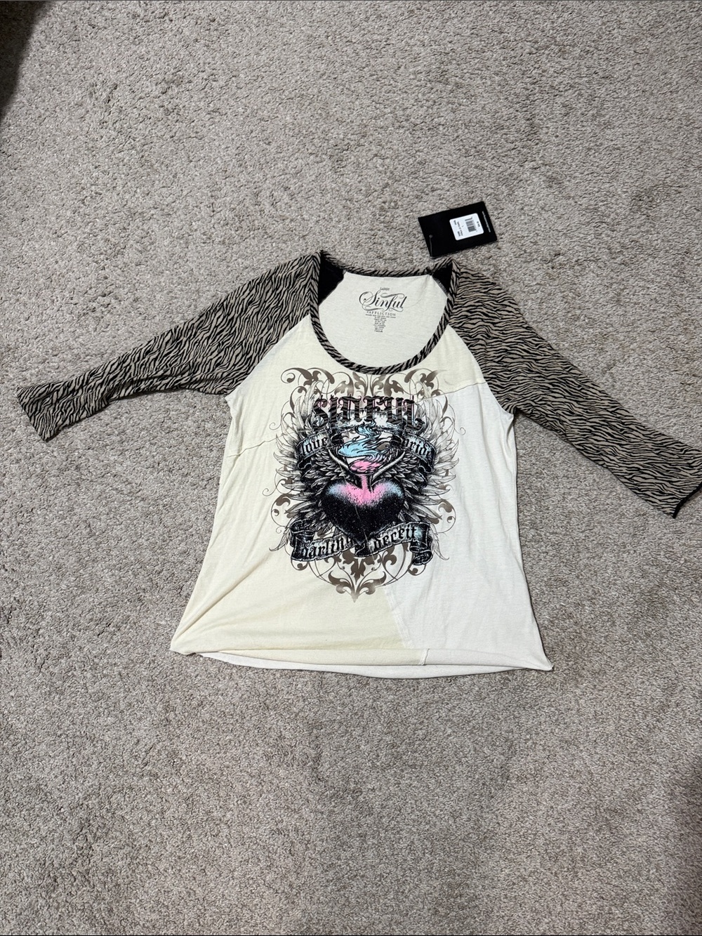 Sinful Cream Raglan Tee with Black Zebra-Print Sleeves and Heart Graphic